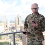 Man in military getting ready to video chat